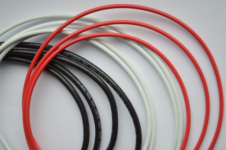 loose pile of black, red, and white power cables with UL markings