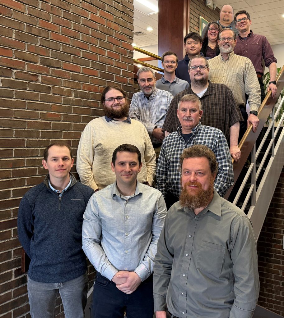 Group of engineers on stairs at New England Wire Technologies